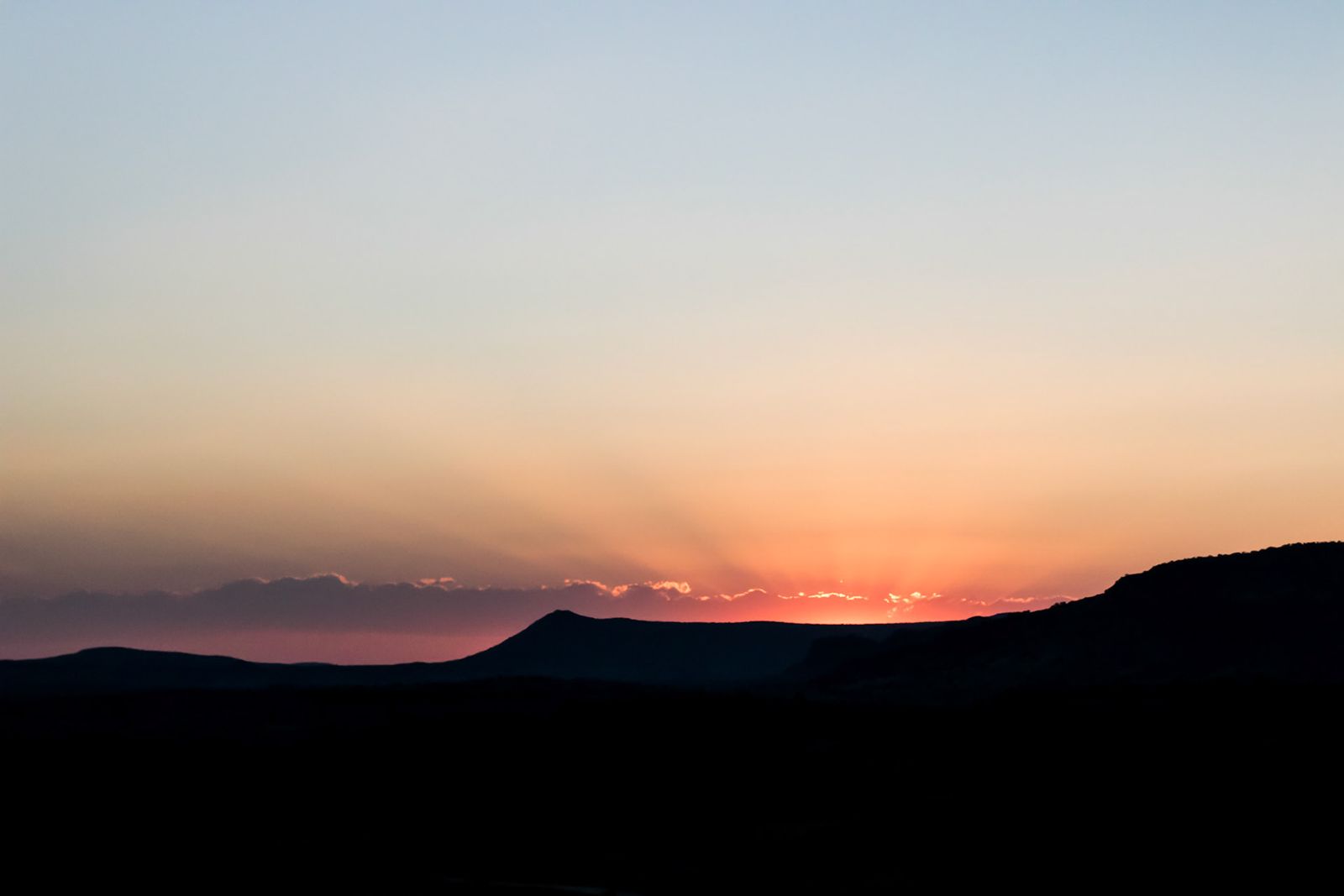 Layered desert mountains at last light