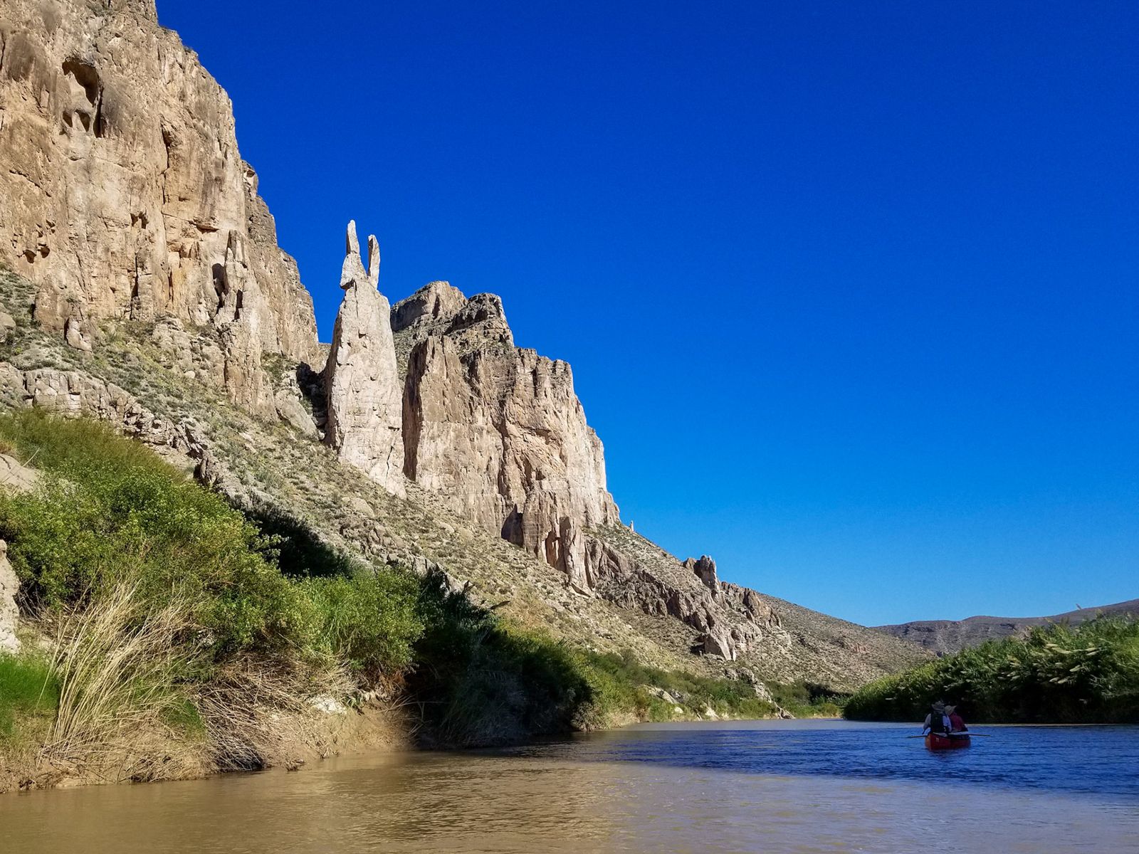Eroded hoodoo formations above the river bottom