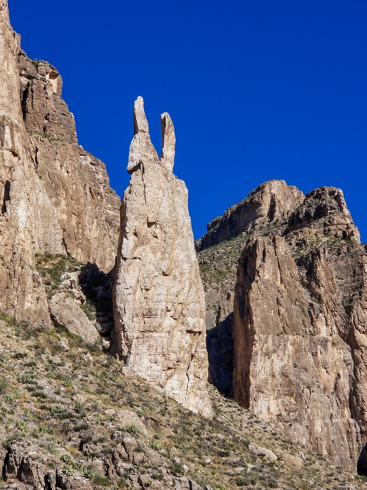 Twin rock spires standing over the desert floor