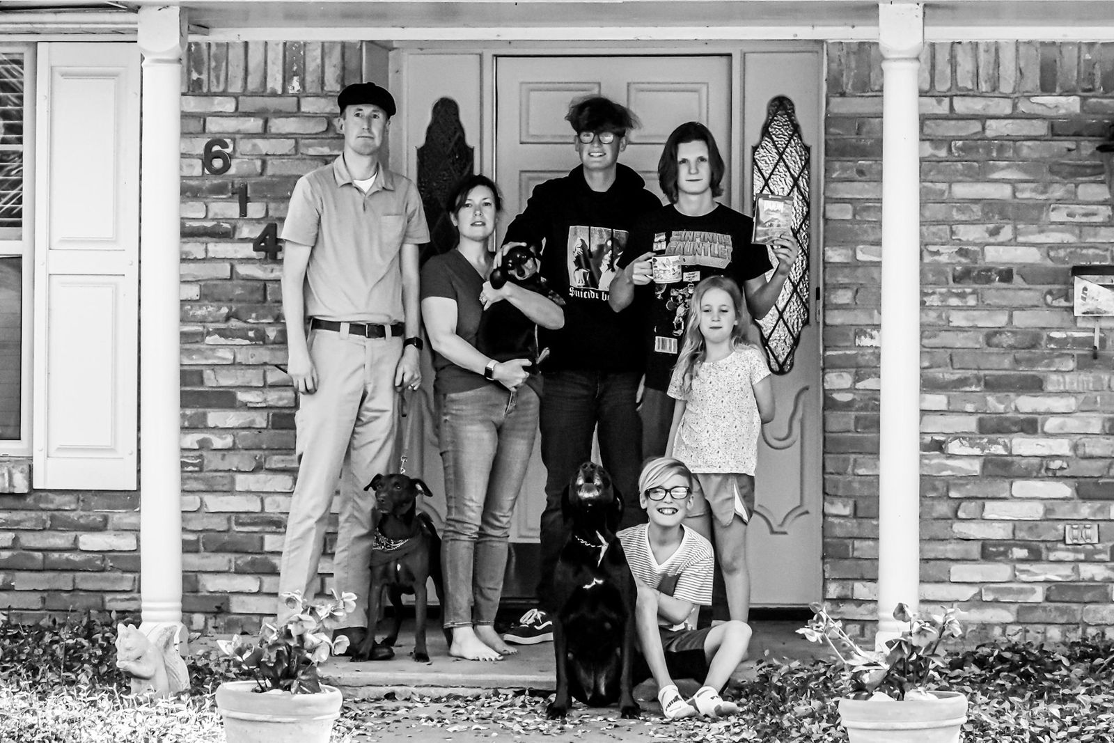 Family posed together on their front porch